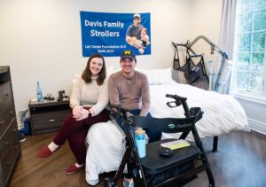 Brian Davis and Katy McNeil in their bedroom, with Brian's ALS equipment in view.
